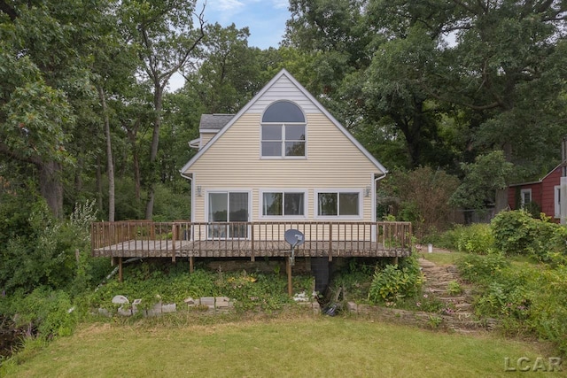 back of property featuring a yard and a wooden deck