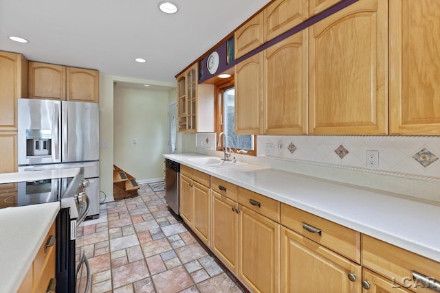 kitchen with decorative backsplash, sink, and stainless steel appliances