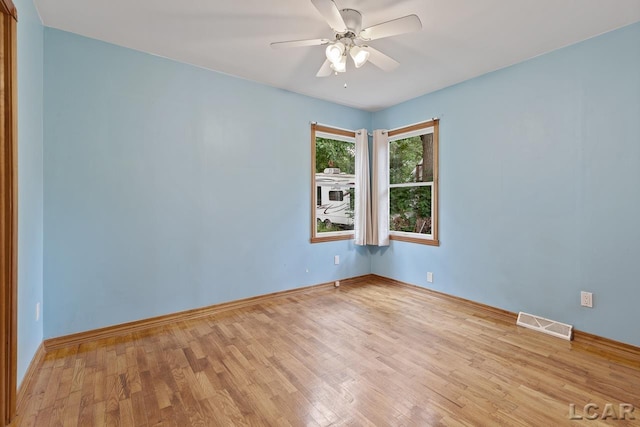 unfurnished room featuring ceiling fan and light wood-type flooring