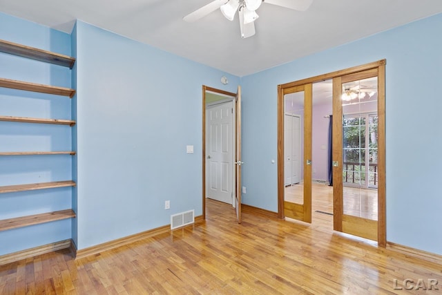 unfurnished bedroom with french doors, light hardwood / wood-style flooring, and ceiling fan