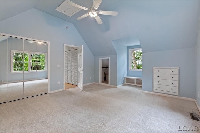 additional living space with ceiling fan, light colored carpet, and vaulted ceiling