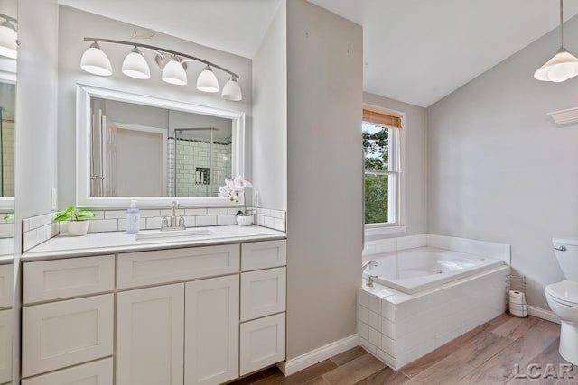 full bathroom featuring plus walk in shower, hardwood / wood-style floors, lofted ceiling, toilet, and vanity