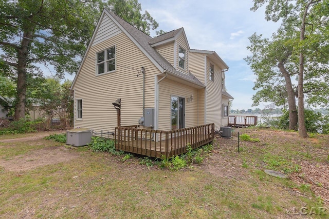 back of property with a deck and central air condition unit