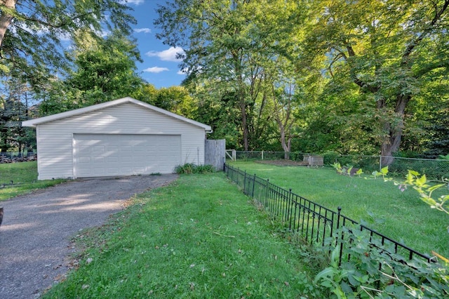 garage featuring a lawn