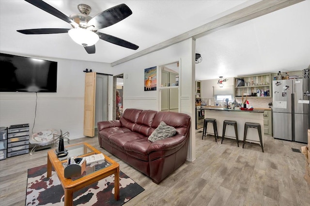 living room featuring light wood-type flooring and ceiling fan