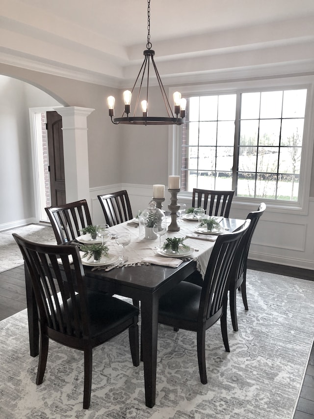 dining area featuring hardwood / wood-style floors and a notable chandelier