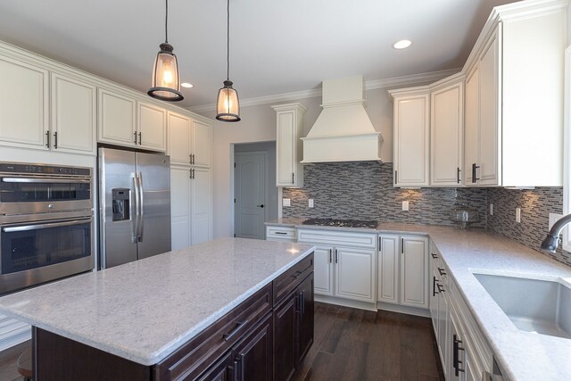 kitchen with premium range hood, dark wood-type flooring, sink, a kitchen island, and stainless steel appliances