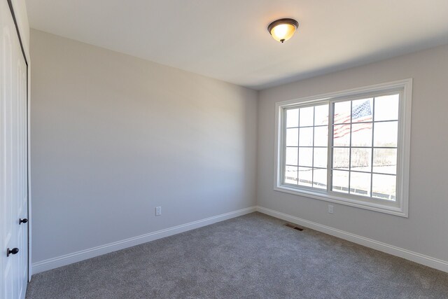 7113 Oak Ridge Ct, Clarkston, MI 48348 - carpeted spare room featuring baseboards