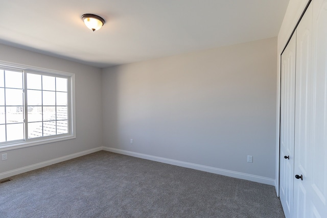 empty room featuring dark colored carpet