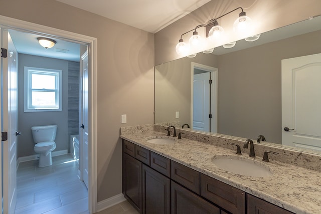 bathroom featuring vanity and toilet