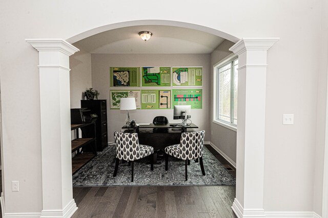 7113 Oak Ridge Ct, Clarkston, MI 48348 - home office with ornate columns, arched walkways, dark wood-style flooring, and baseboards