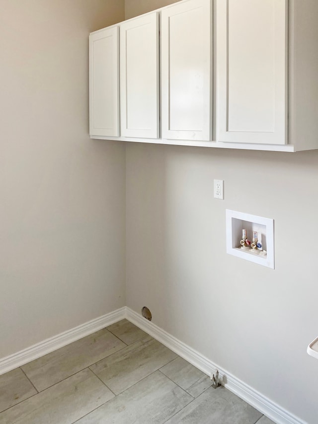 laundry area featuring washer hookup and cabinets