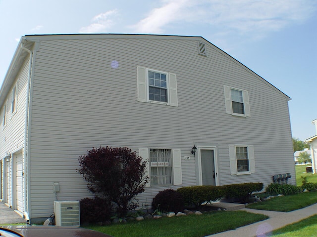 view of front of house featuring central air condition unit and a garage