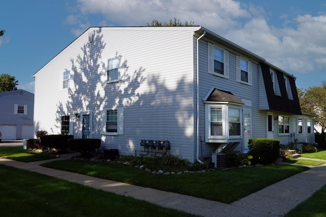 view of side of home with a lawn