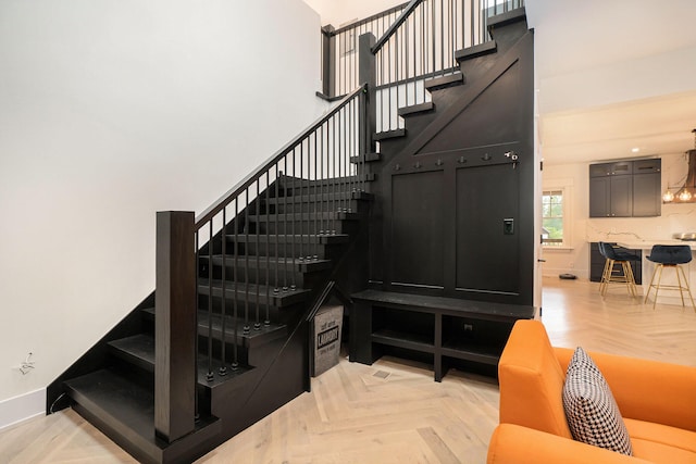 stairs featuring parquet floors