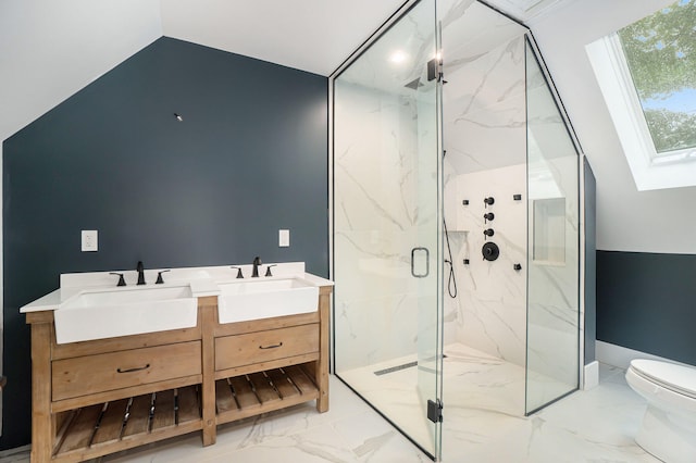 bathroom featuring vanity, toilet, a shower with shower door, and vaulted ceiling with skylight