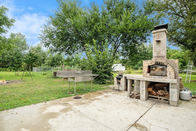 view of patio / terrace with an outdoor stone fireplace