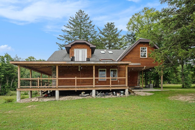 back of property featuring a lawn and french doors