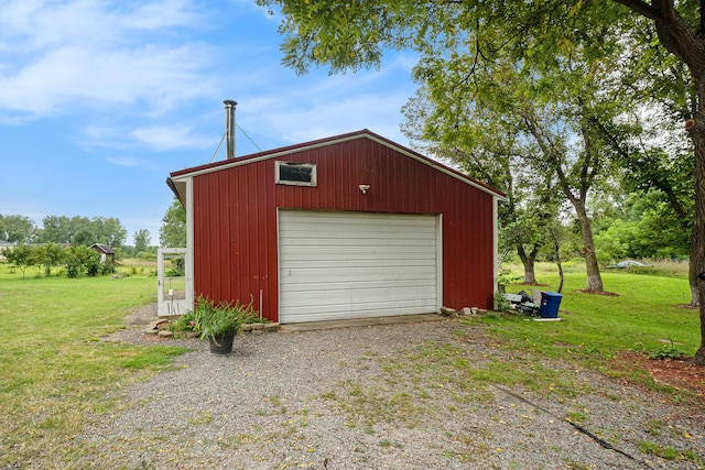 garage featuring a lawn