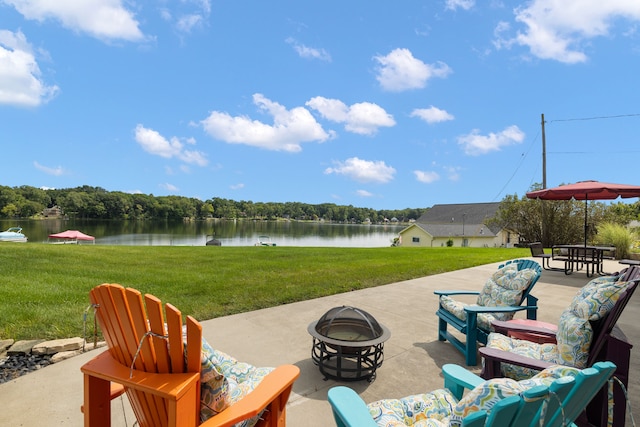 view of patio with a water view and a fire pit