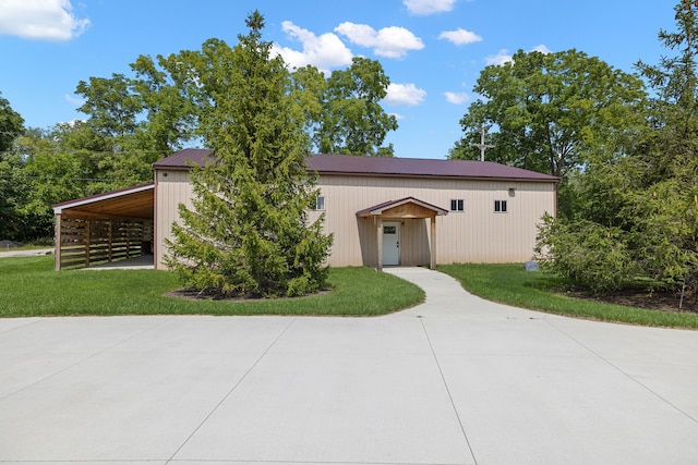 view of front of property with a carport and a front lawn