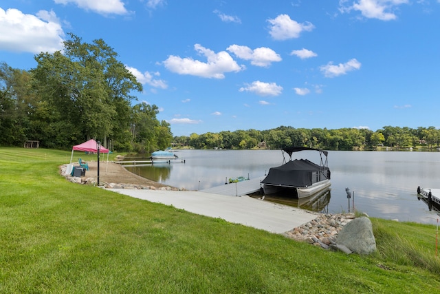 dock area featuring a lawn and a water view