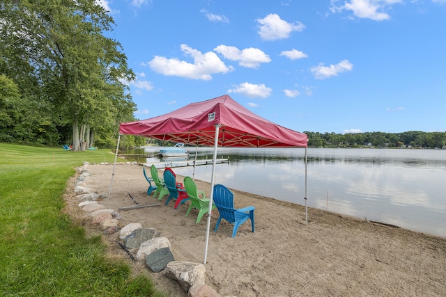 view of property's community featuring a water view and a yard