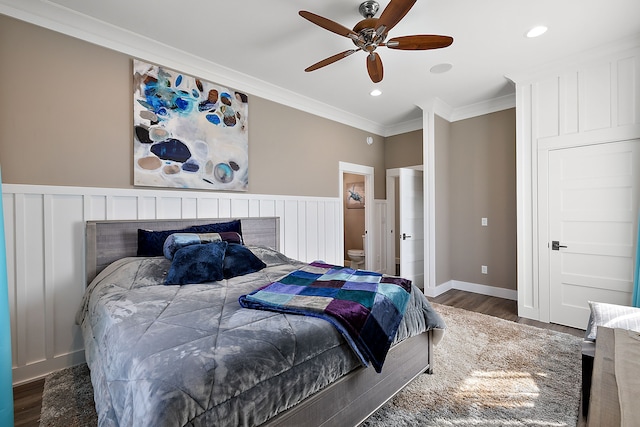 bedroom with ceiling fan, crown molding, and dark hardwood / wood-style floors