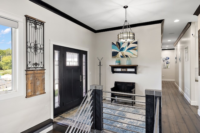 foyer with plenty of natural light, dark hardwood / wood-style flooring, and ornamental molding