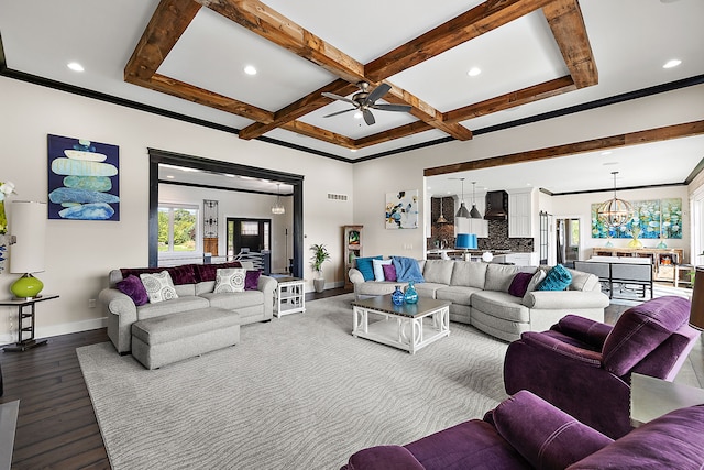 living room featuring coffered ceiling, ceiling fan with notable chandelier, hardwood / wood-style flooring, ornamental molding, and beam ceiling