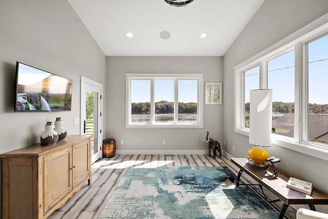 living area featuring vaulted ceiling and light wood-type flooring