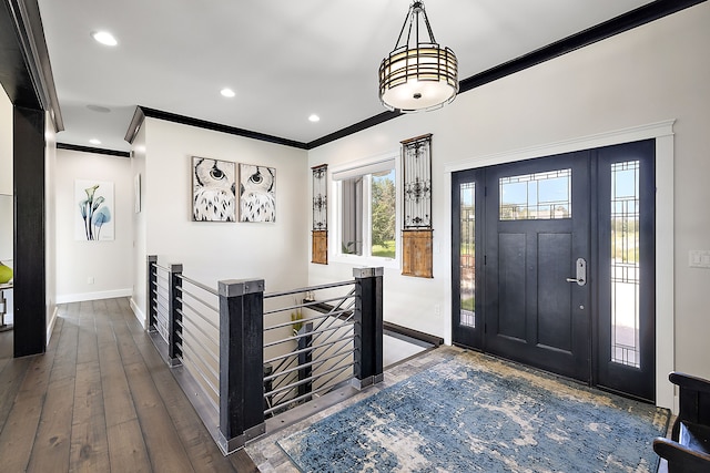 entrance foyer with hardwood / wood-style flooring and ornamental molding