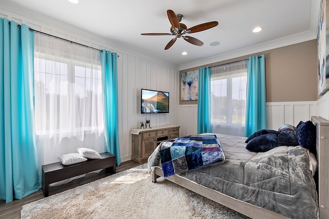 bedroom with ceiling fan, wood-type flooring, and ornamental molding