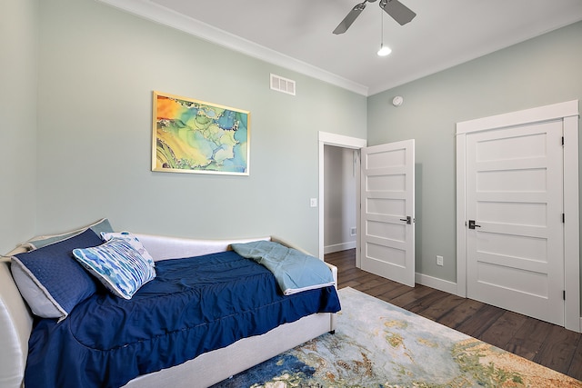 bedroom with ceiling fan, dark hardwood / wood-style flooring, and crown molding