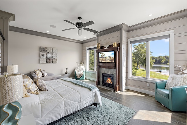 bedroom with multiple windows, ceiling fan, crown molding, and wood-type flooring