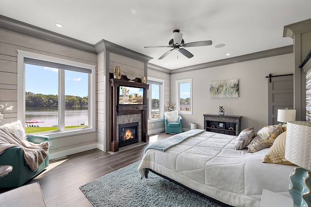 bedroom featuring ceiling fan, a water view, dark hardwood / wood-style floors, and ornamental molding