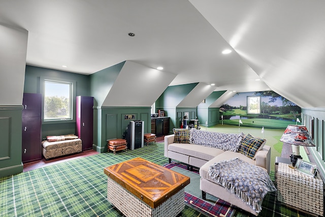 living room featuring wood-type flooring, a wealth of natural light, and lofted ceiling