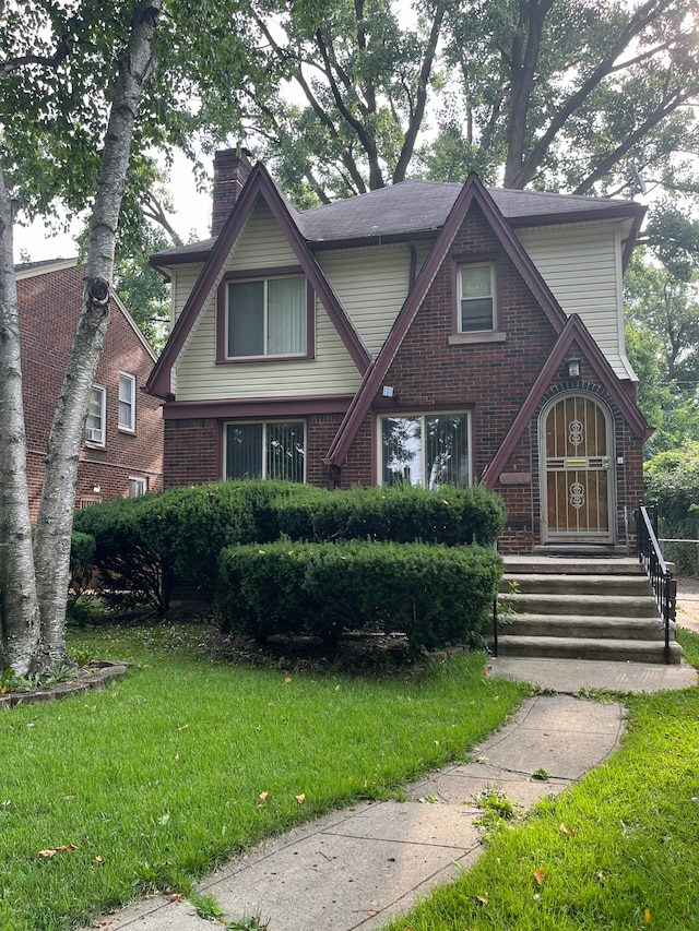 tudor home featuring a front lawn