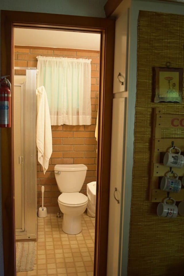 bathroom featuring tile patterned floors and toilet