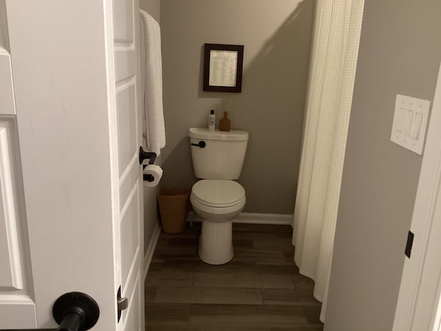 bathroom with hardwood / wood-style floors and toilet