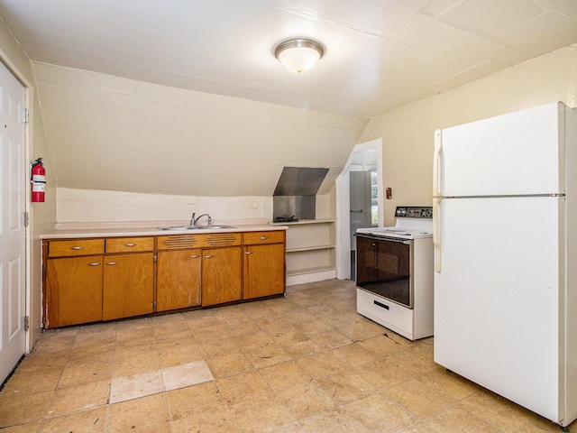 kitchen with lofted ceiling, white appliances, and sink