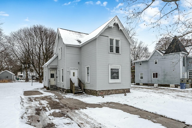 view of snow covered back of property