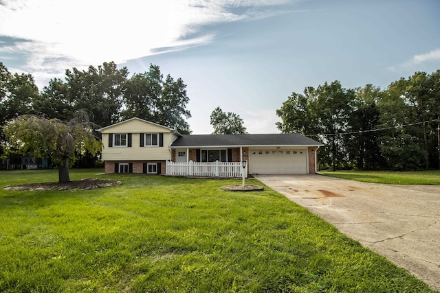 split level home featuring a front lawn and a garage