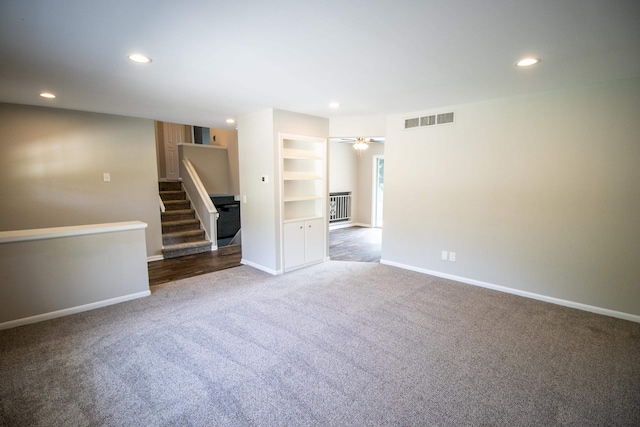 unfurnished room featuring dark colored carpet