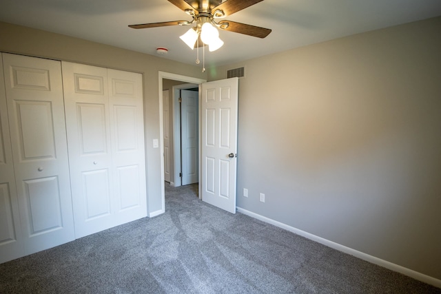 unfurnished bedroom with ceiling fan, carpet floors, and a closet