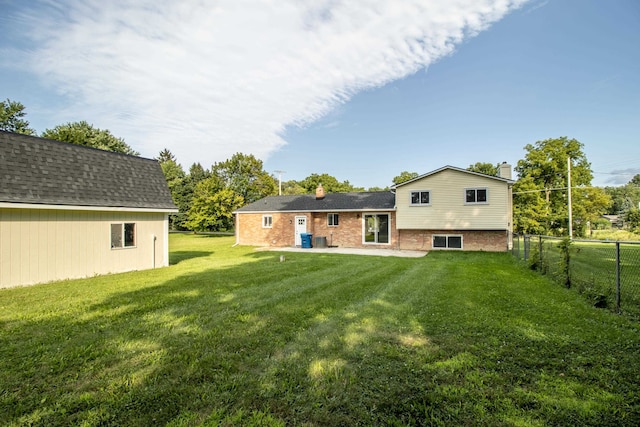 rear view of house featuring a yard