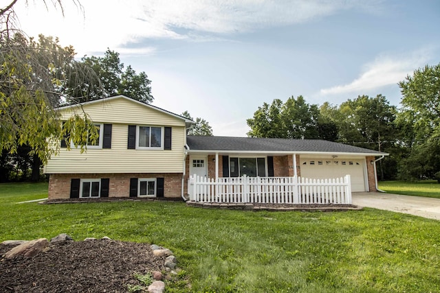 split level home featuring a front yard and a garage