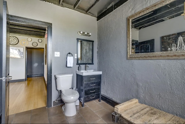 bathroom featuring vanity, toilet, and wood-type flooring