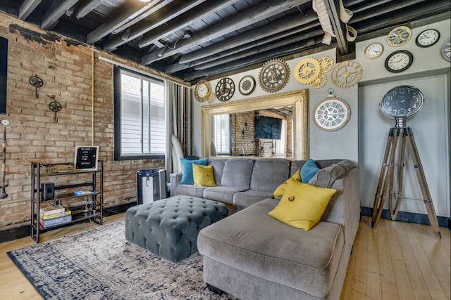 living room with beamed ceiling, wood-type flooring, and brick wall