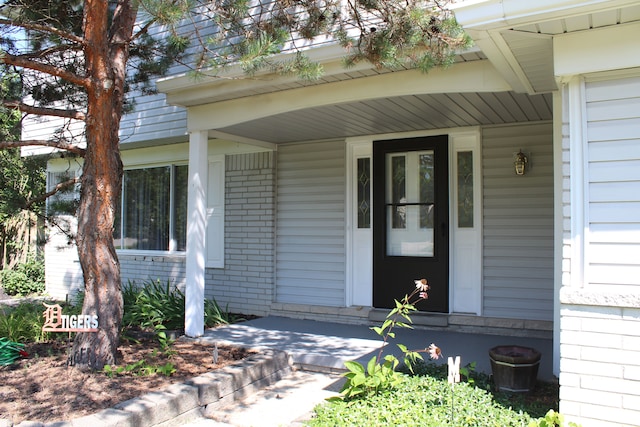 29352 Medburn Ct, Farmington Hills, MI 48336 - view of exterior entry featuring brick siding and a porch